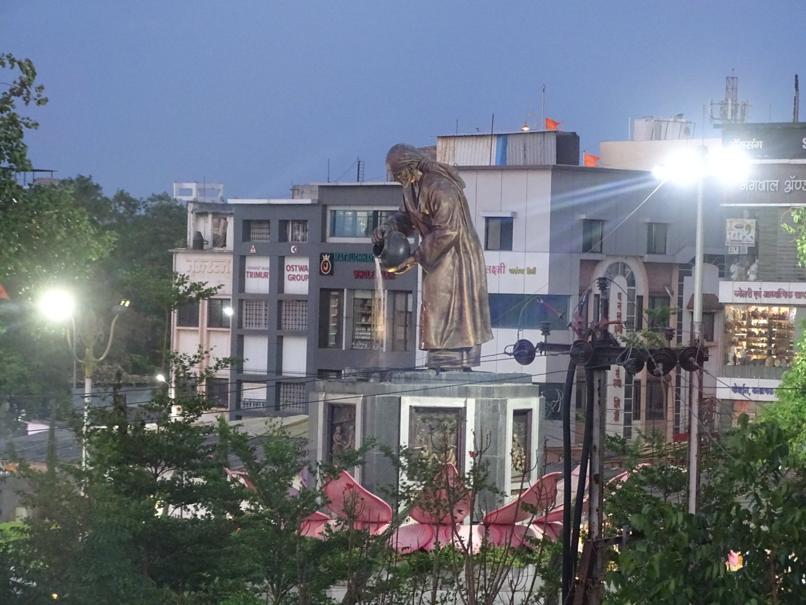 Shri Saibaba statue near the Samadhi Mandir, Shirdi, lit up in the evening, seen from Hotel Saikrupa